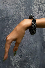 hand with handcrafted beaded nyx supple cuff in jetblack by object and dawn
