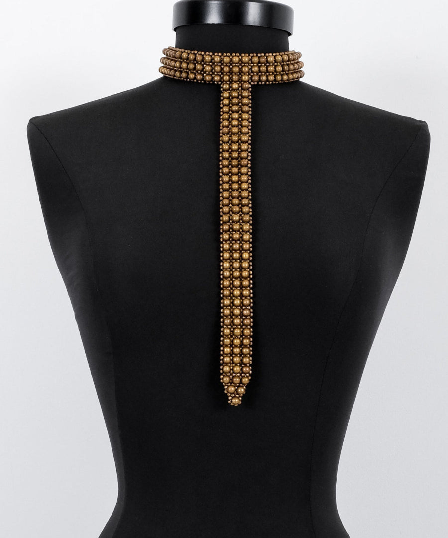 Signature Slim T-Choker Antq gold on a black mannequin against a white background by Object & Dawn