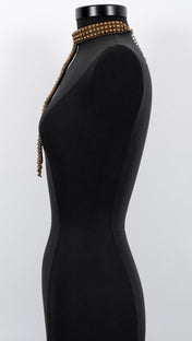 Signature Slim T-Choker Antq Gold on a mannequin against a white background by Object & Dawn.