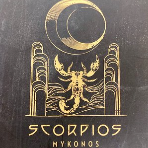 Gold Scorpio symbol and 'Scorpios Mykonos' text on a black background by Object & Dawn