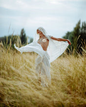 woman wears harness skirt and lace robe in white by object & Dawn on the oats fields