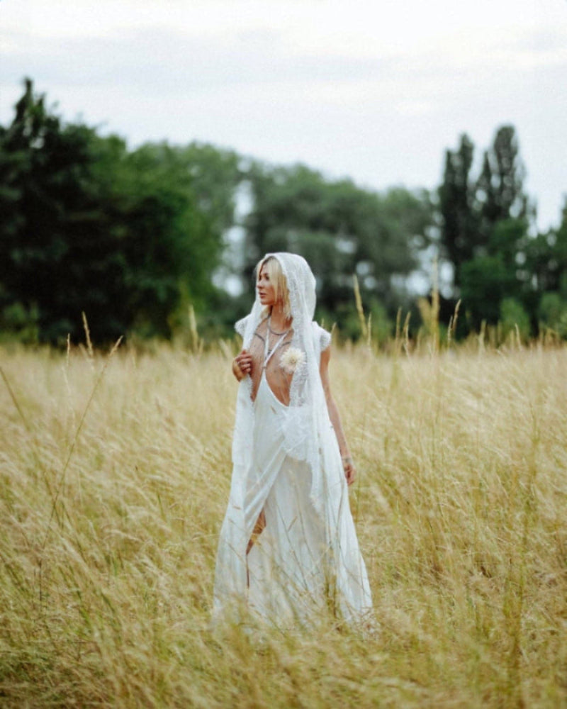 woman wears harness skirt and lace robe in white by object & Dawn on the oats fields