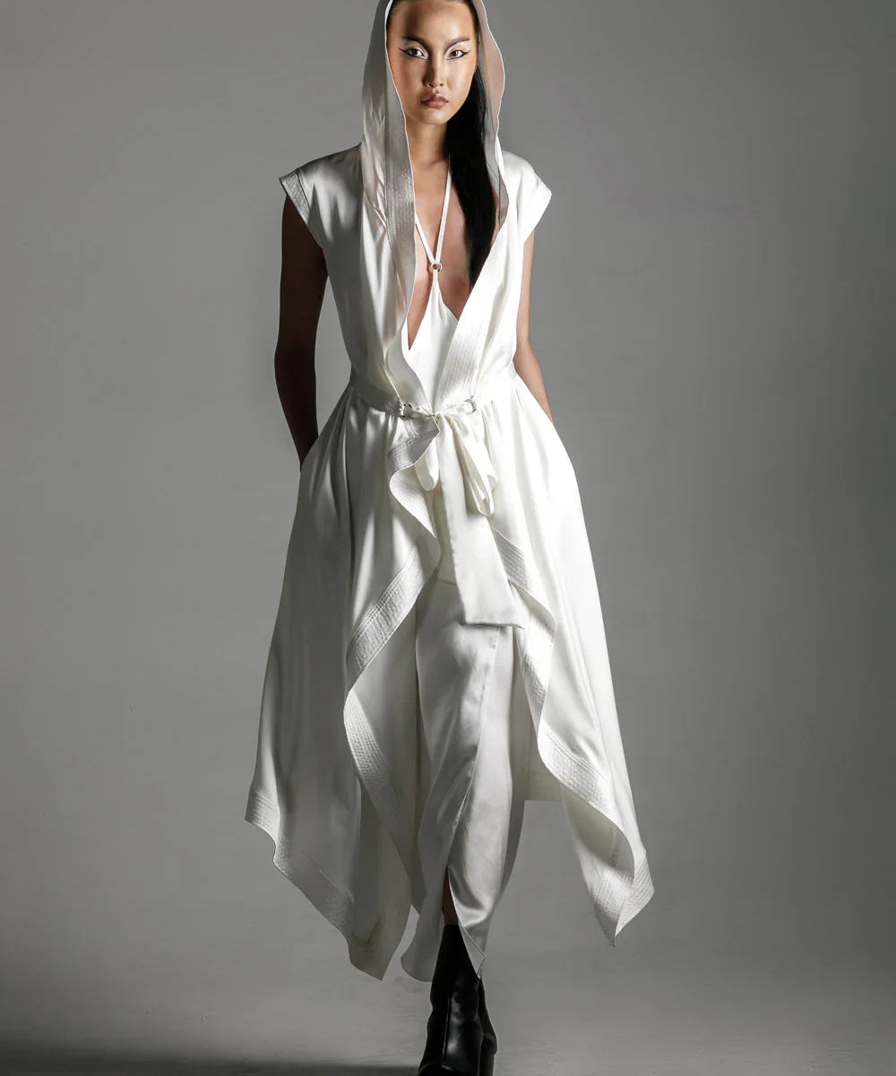 woman with luxury silk top stiched hooded cap and tamoe silk harness skirt in white by object and dawn