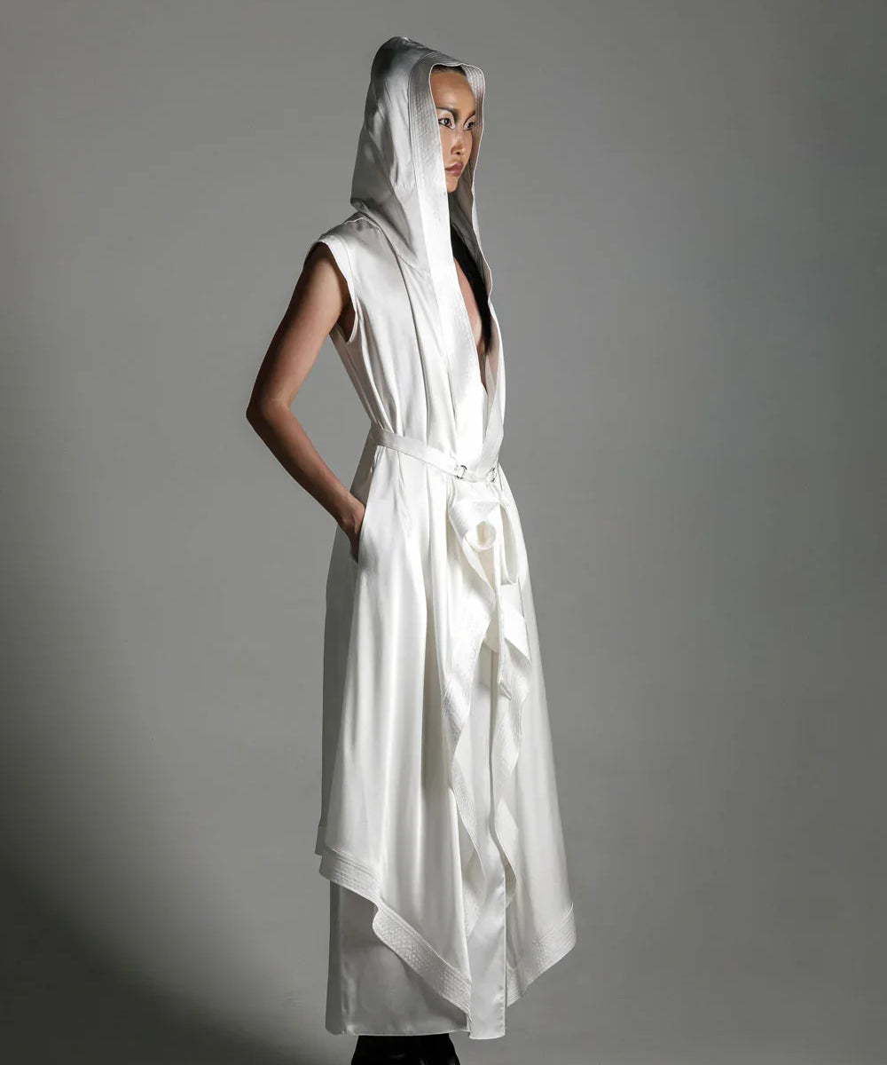 woman with luxury silk top stiched hooded cap and tamoe silk harness skirt in white by object and dawn