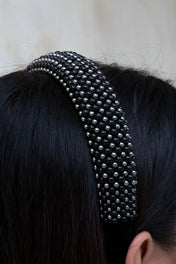 Silver beaded  with black crystals Teuta headband by Object & Dawn worn by a person with a neutral background