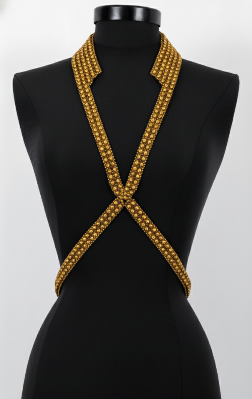 Black mannequin wearing a V-Necklace Harness gold by Object & Dawn  against a white background