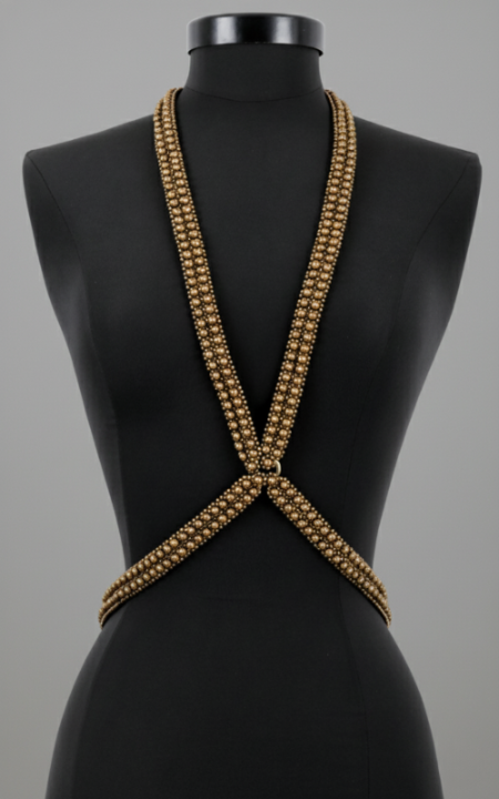 X-Shape Harness Necklace gold on a black mannequin against a gray background by Object & Dawn