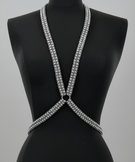 Silver strappy top on a black mannequin against a gray background