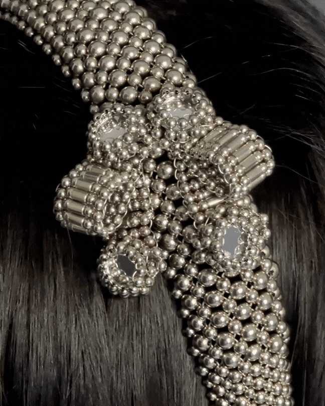 Woman wearing Amaa Bow Headband in Silver by Object&Dawn in grey background