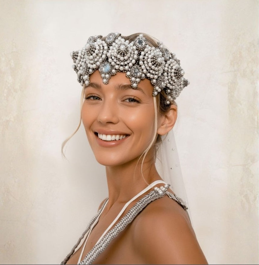 Woman wearing a decorative headpiece with a neutral background