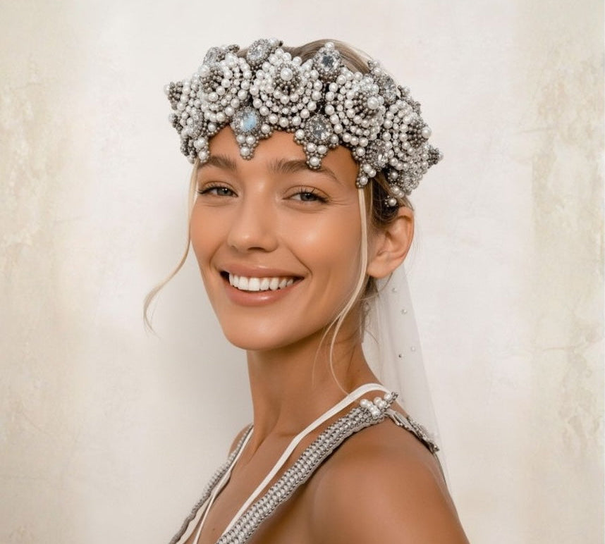 Woman wearing a decorative headpiece with a neutral background