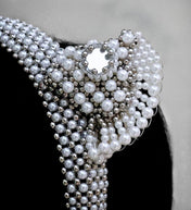 pearl beaded Jas headband worn by a person with a neutral background