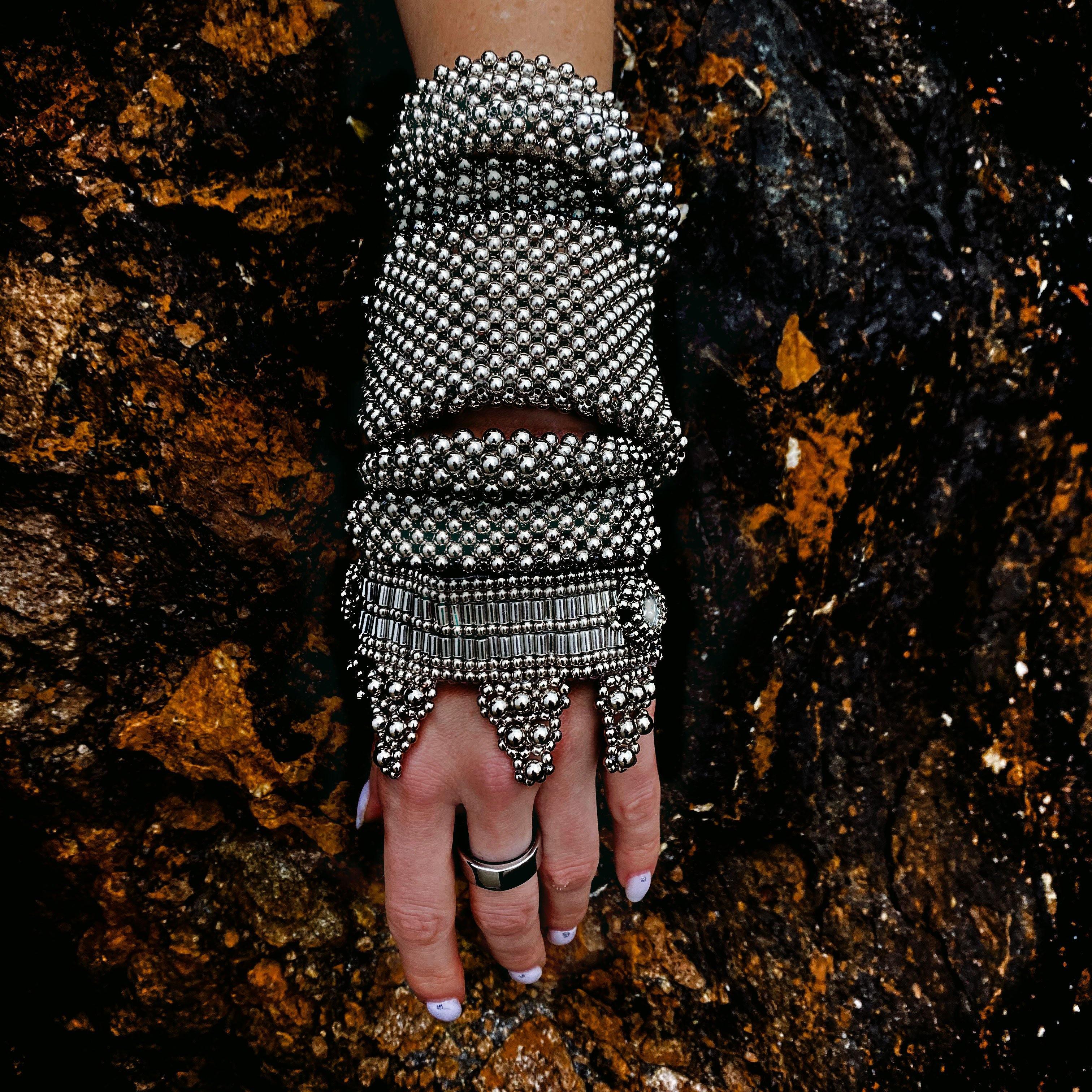 Object & Dawn beaded wrist accessory in ivory, structured supple cuff with polymer metal beads, ghost image