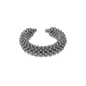 Object & Dawn beaded wrist accessory in ivory, structured supple cuff with polymer metal beads, ghost image front view