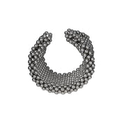 Object & Dawn beaded wrist accessory in ivory, structured supple cuff with polymer metal beads, ghost image diagonal view