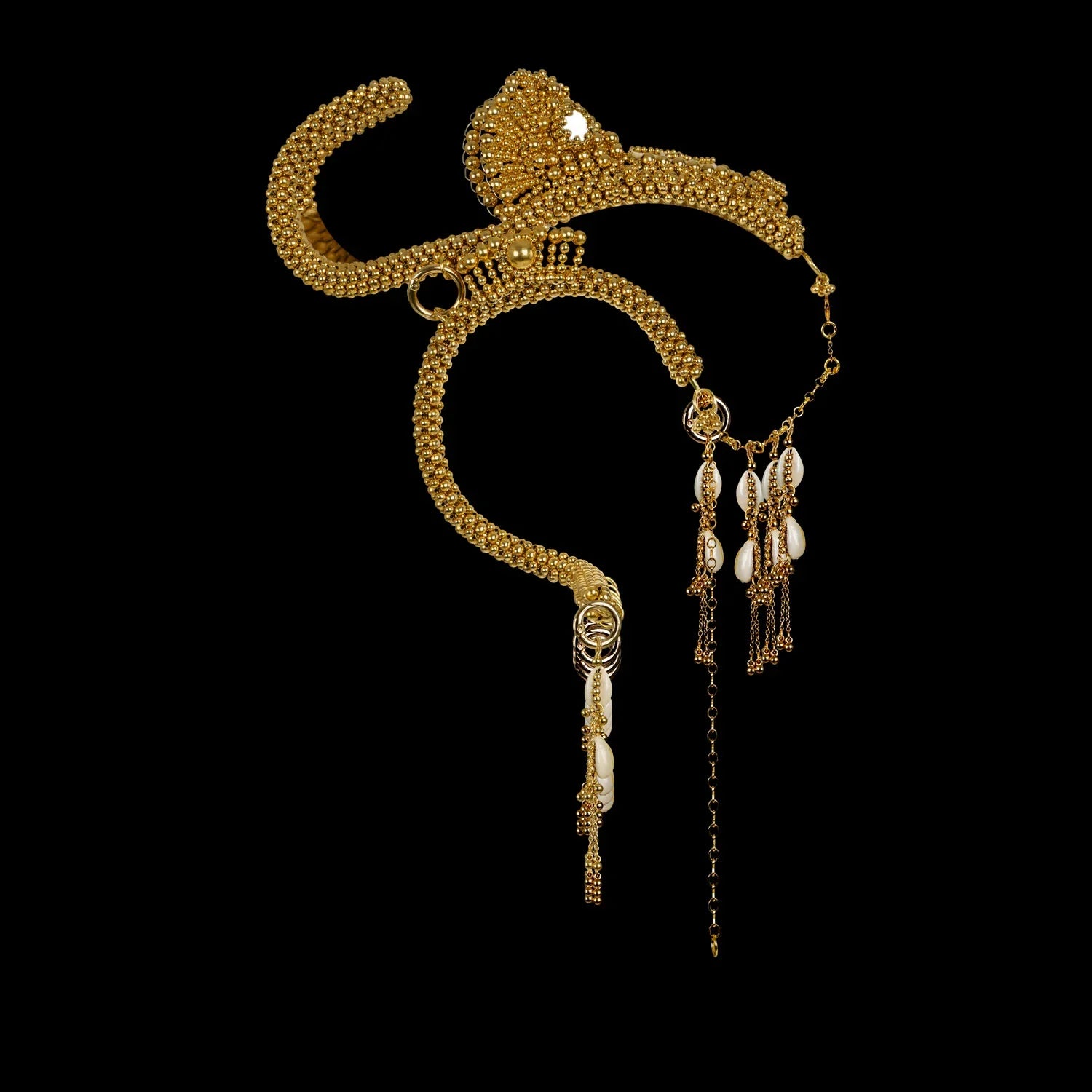 modular beaded jas headpiece system from 22 gold washed metal beads with shell beaded tassel from object and dawn in black background diagonal view