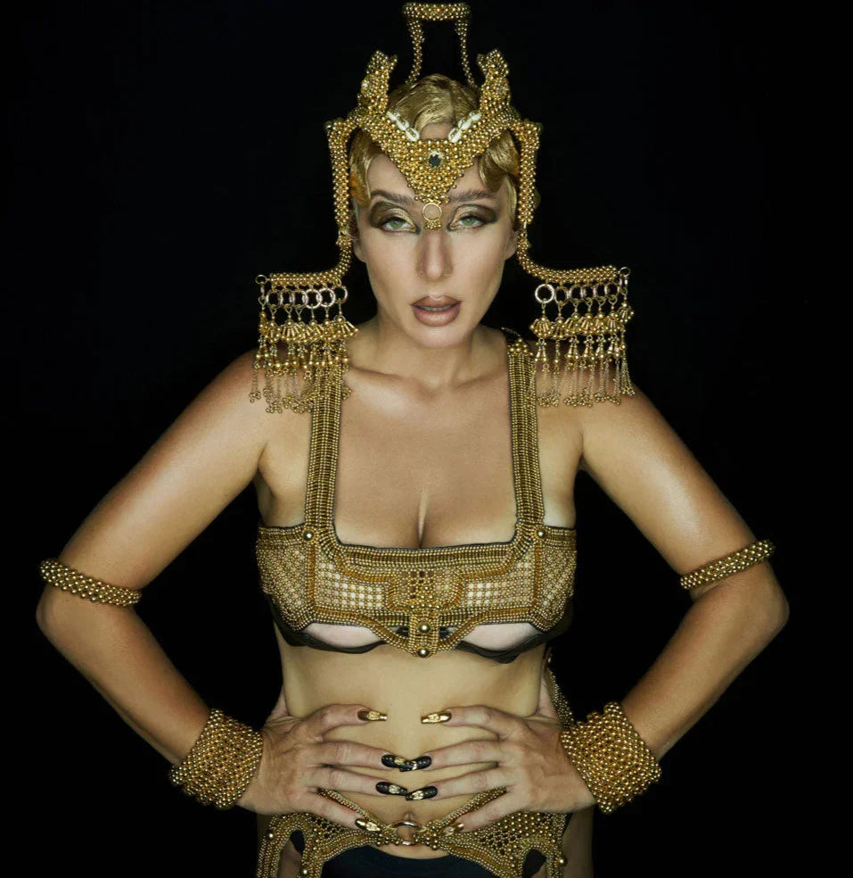 woman in gold beaded harness top with leather bra from 22k gold wash on each metal beads by object and dawn