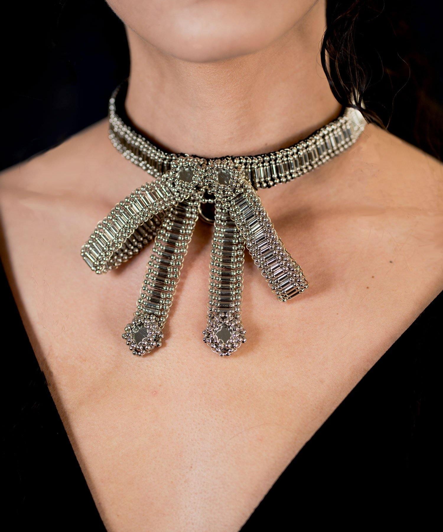 Amaya Choker by Object and Dawn is constructed entirely by hand with high quality metal beads that coated in polymer to preserve shine and ensure the item is hypoallergenic.  Ethically made by a team of our skilled in house artisans, with ancient techniques.  Fully lined in velvet for your ultimate comfort.
