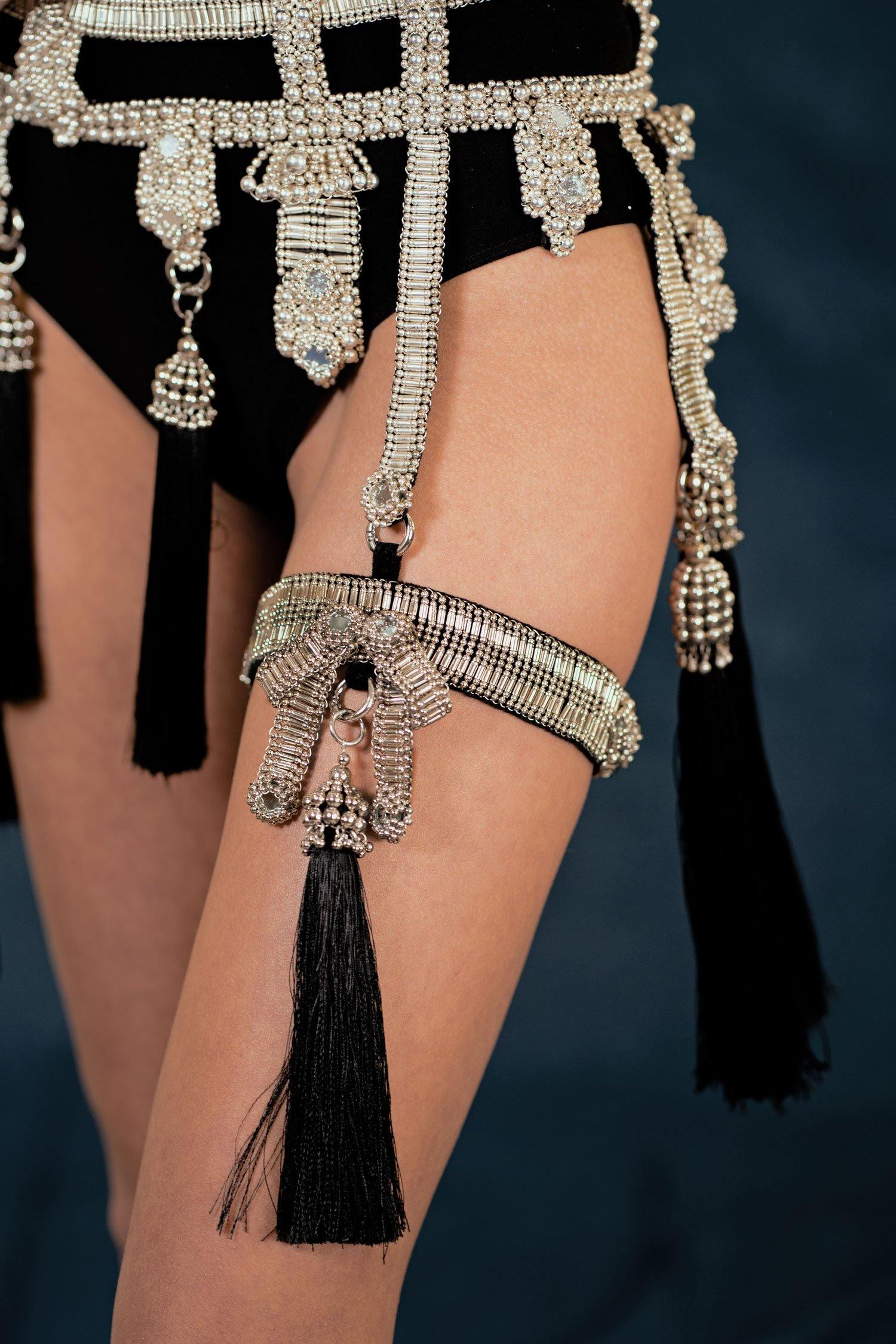 Amaya Garter Band by Object and Dawn. Power is sexy. You'll feel both wearing this one.   Our skilled artisans use an ancient and disappearing technique to construct your piece. Made with high quality metal beads that are coated in polymer to preserve shine and ensure the item is hypoallergenic. The garter band is fully lined by hand in luxurious velvet and has an adjustable elastic strap to comfortably fit to your thigh circumference.