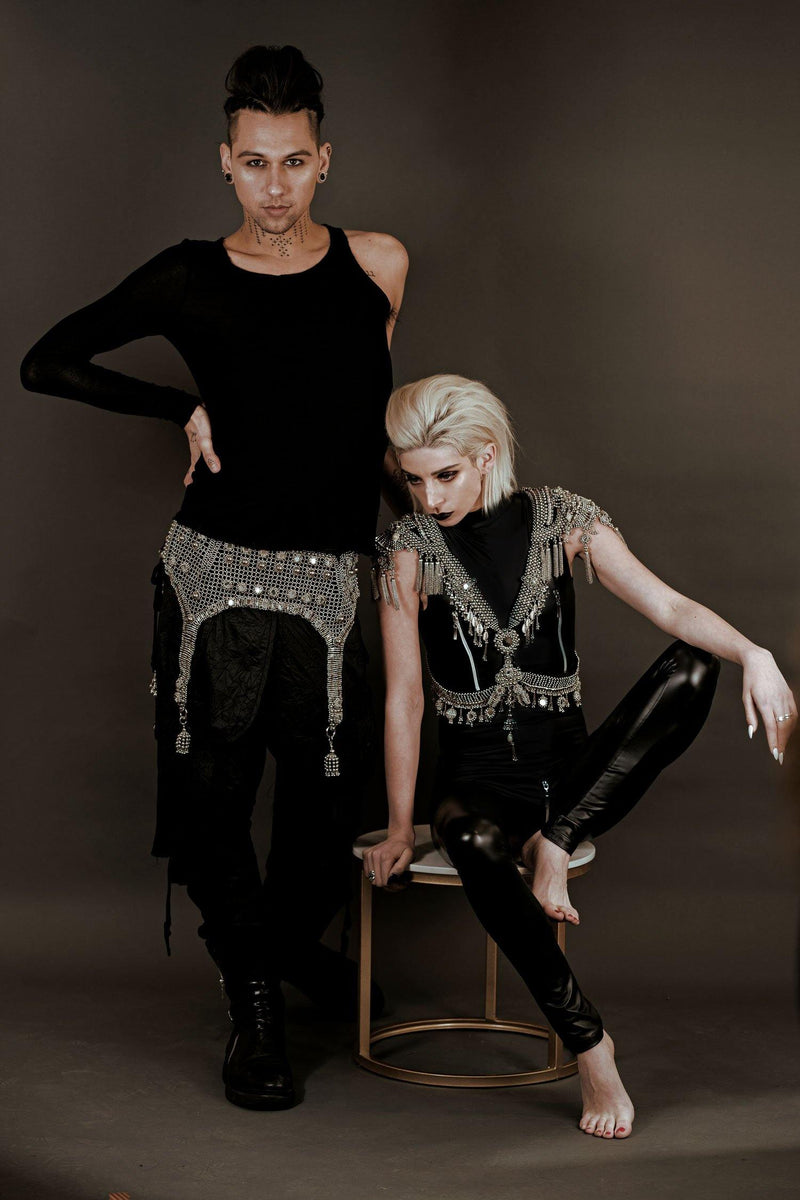 Hera Modular Harness by Object and Dawn is constructed with high quality metal beads that are coated in polymer to preserve shine and ensure the item is hypoallergenic.  Ethically made with secret ancient techniques by our skilled artisans, each piece takes several days to make. The harness is accented with hand cut mirror clusters, locally harvested cowrie shells, custom metal chain tassels and intricate black crystals.  This piece is fully lined by hand in luxurious velvet for your ultimate comfort.